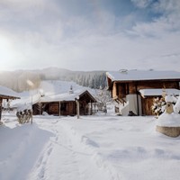 Snow-covered chalets in winter sunshine, Puradies Leogang