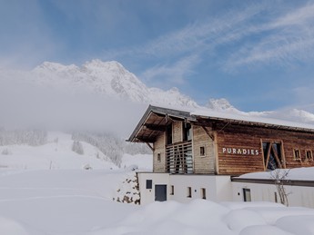 Sauna House in snow beneath mountain panorama, Puradies Leogang