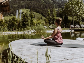 Yoga at the Natural Swimming Pond at Naturresort Puradies Yoga meditation at the Natural Swimming Pond with mountain view, Naturresort Puradies